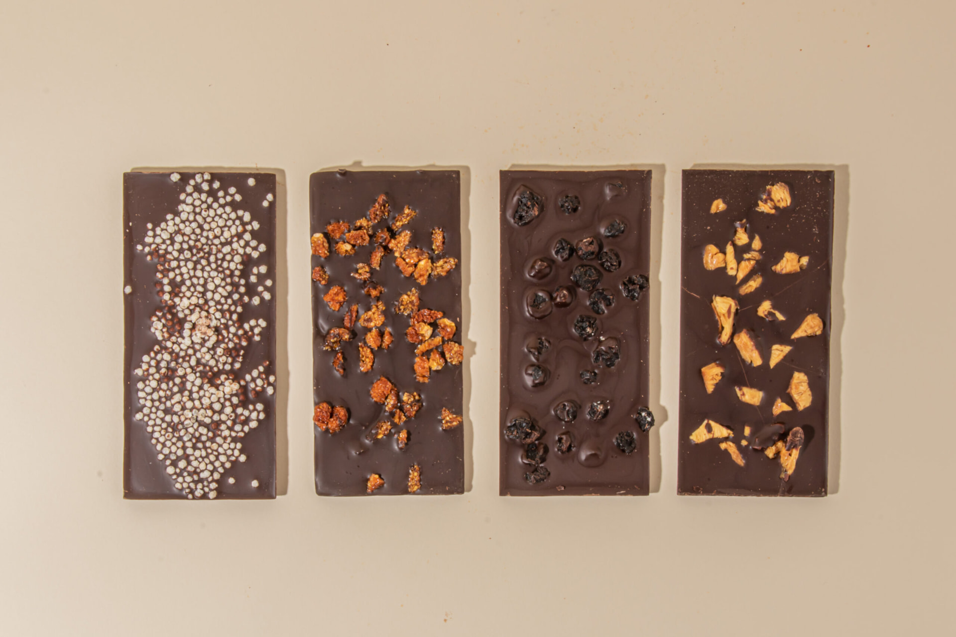Four Kuyay dark chocolate bars with quinoa, goldenberry, blueberry and mango