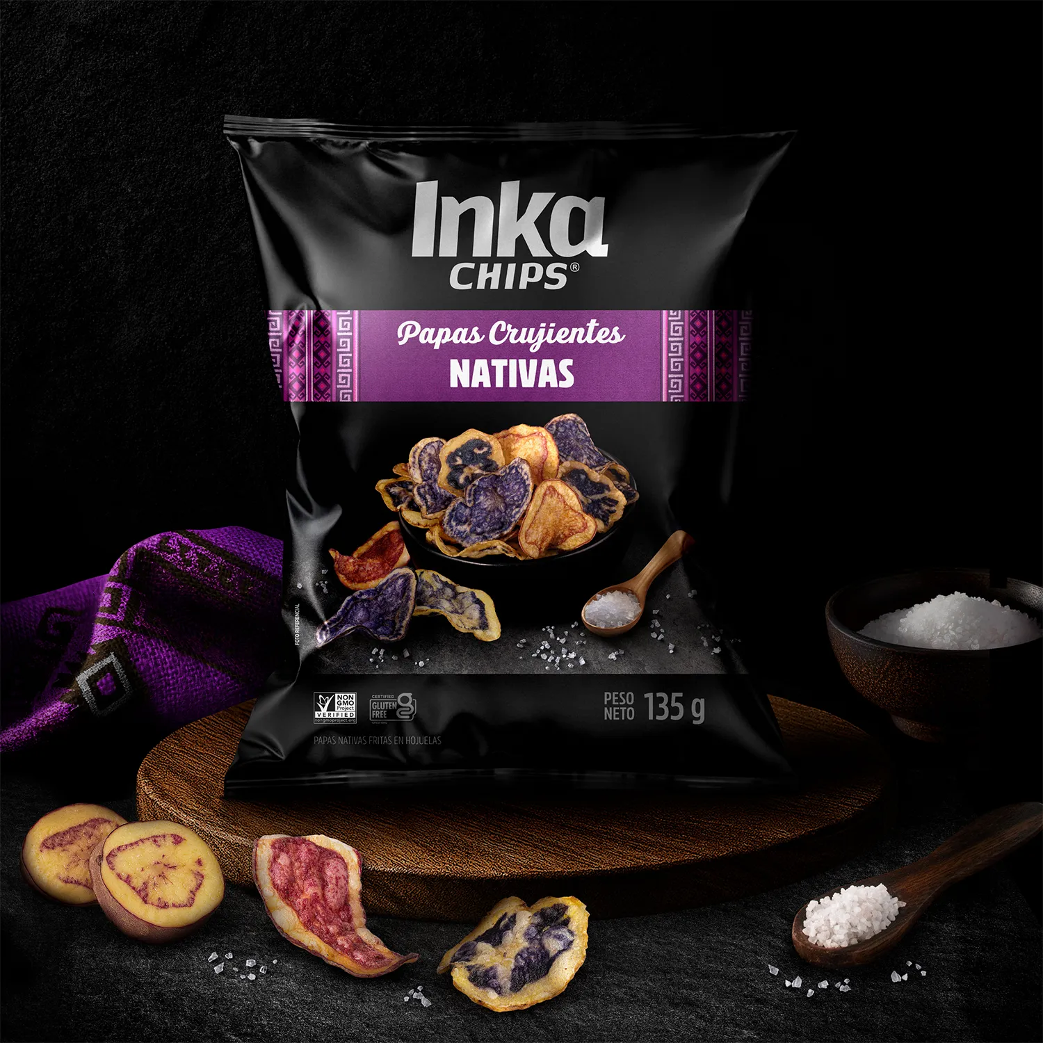 Inka Chips Nativas bag on a wooden board with native potatoes and salt