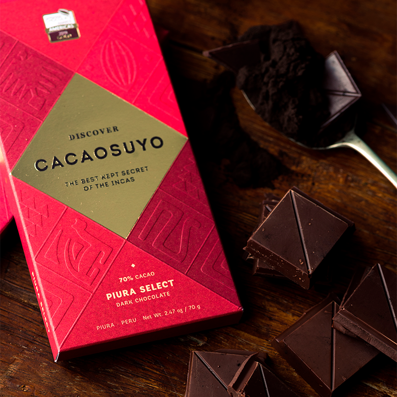 Cacaosuyo Piura Select bar with broken chocolate pieces on dark wood