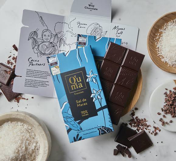 Q'uma Sal de Maras bar open with squares, Maras salt and cacao partner cards