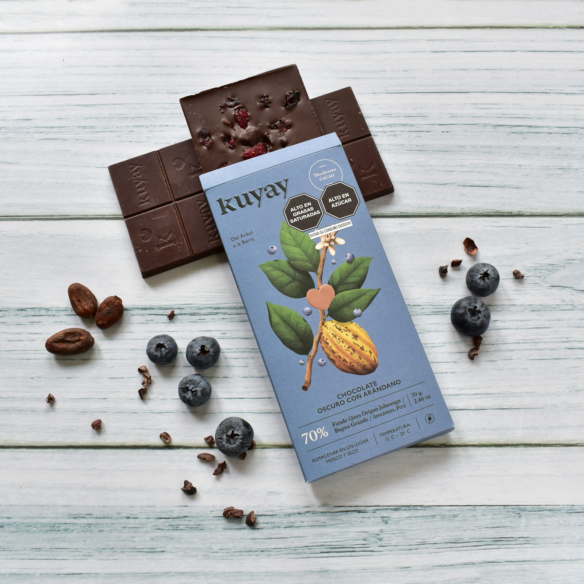 Kuyay arándano bar unwrapped with dried blueberries on white wood
